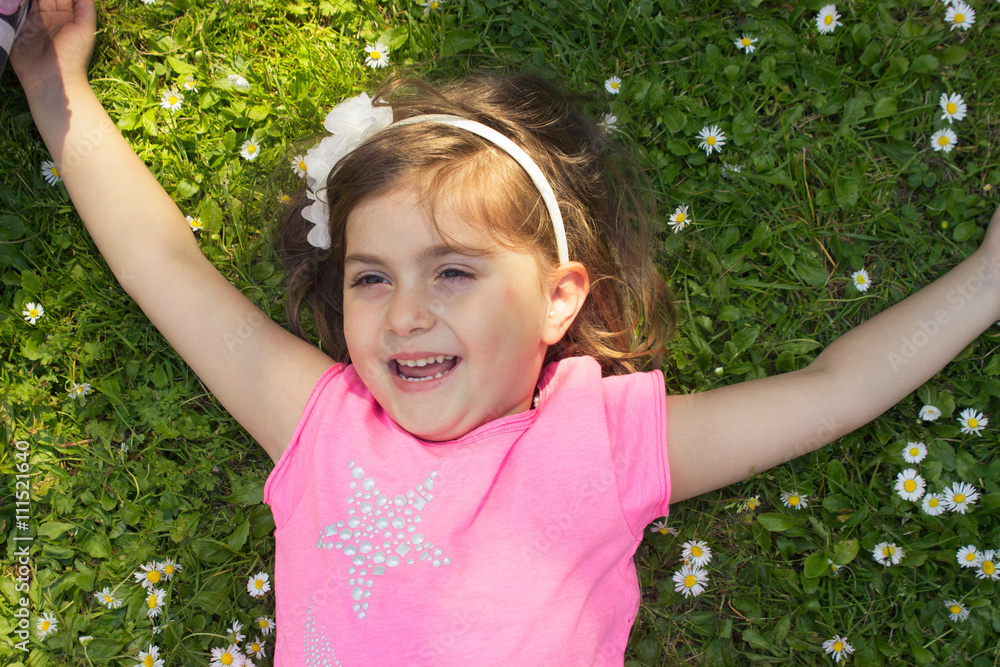 Little girl laying in the grass Little girl laying in the grass