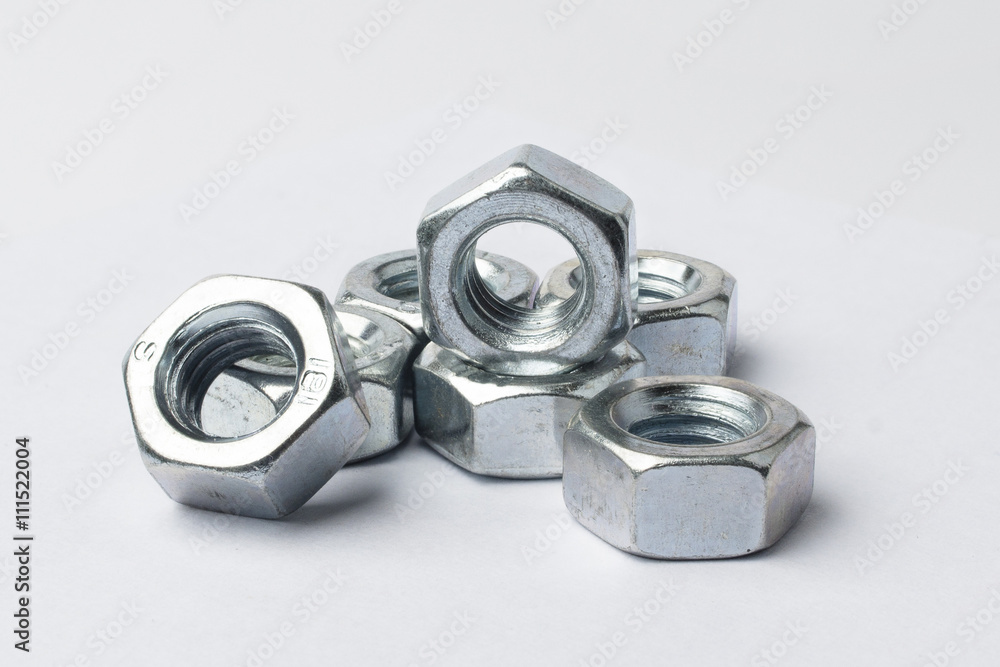 metal nuts on a white background metal nuts on a white background