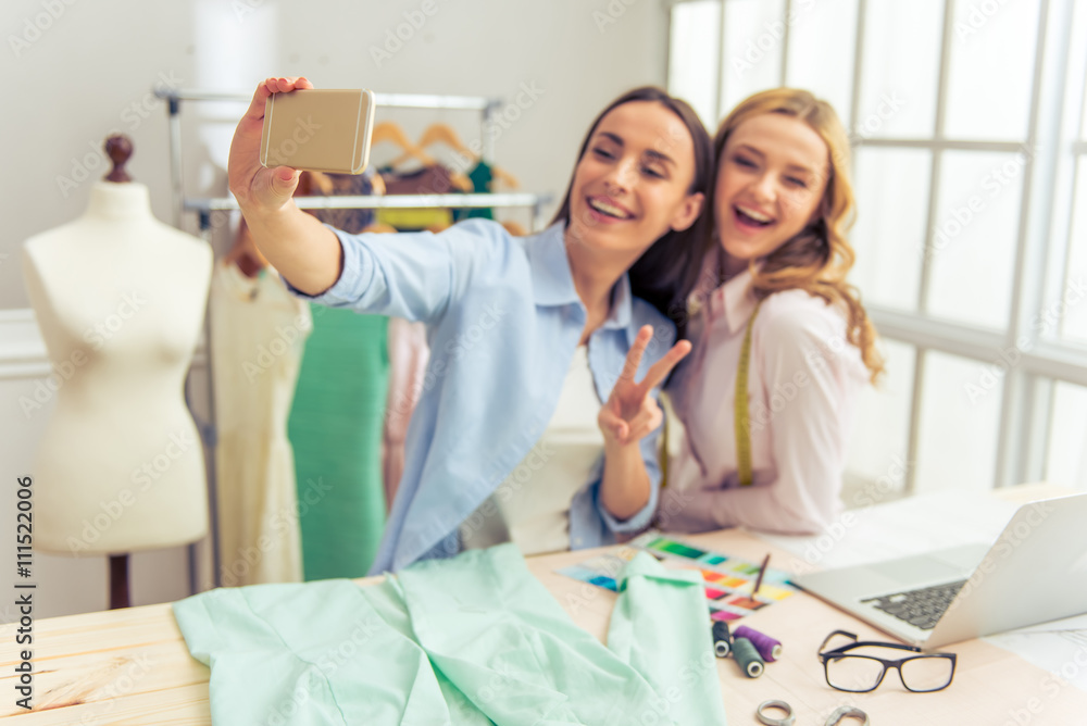 Beautiful young designers with gadget Beautiful young designers with gadget