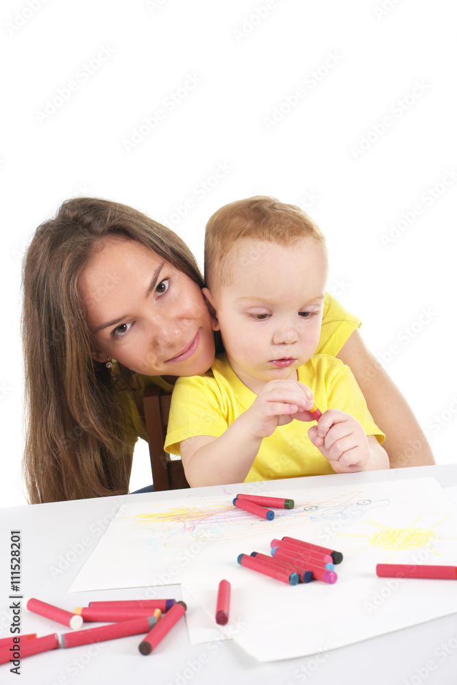 Mother and son are drawing the picture together Mother and son are drawing the picture together