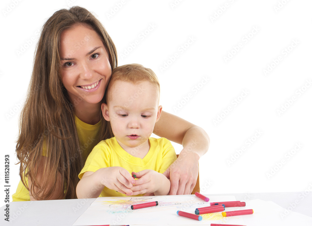 Mother and son are drawing the picture together Mother and son are drawing the picture together