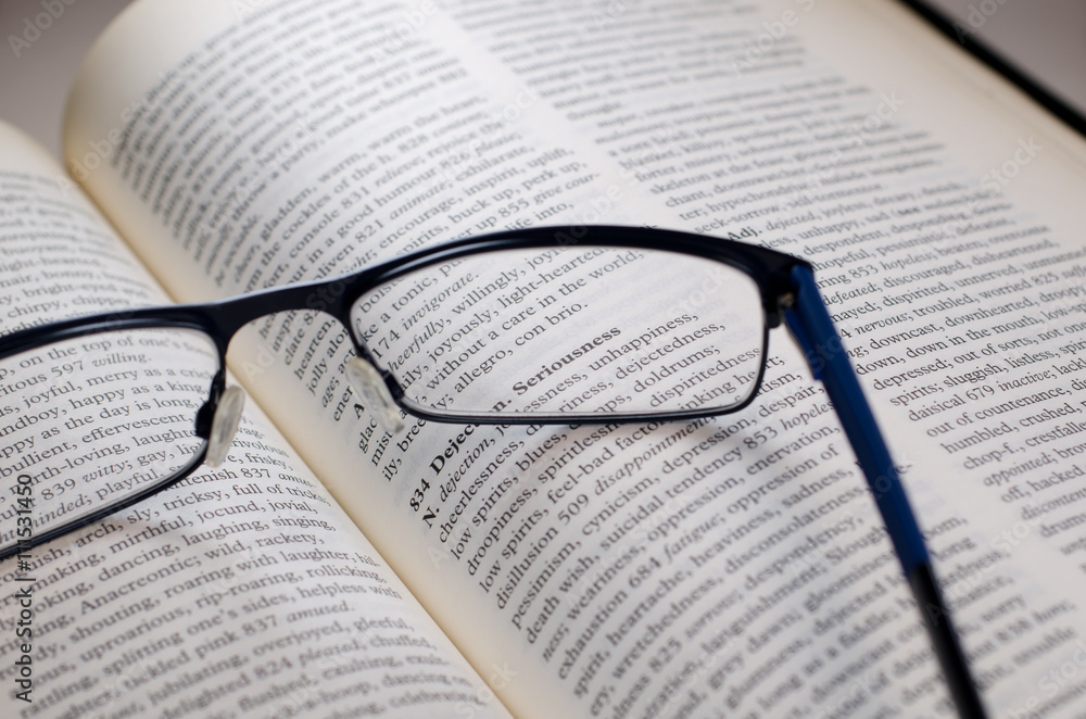 Glasses on book highlighting the word seriousness Glasses on book highlighting the word seriousness