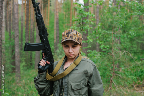 Bild auf Leinwand A woman soldier with a weapon