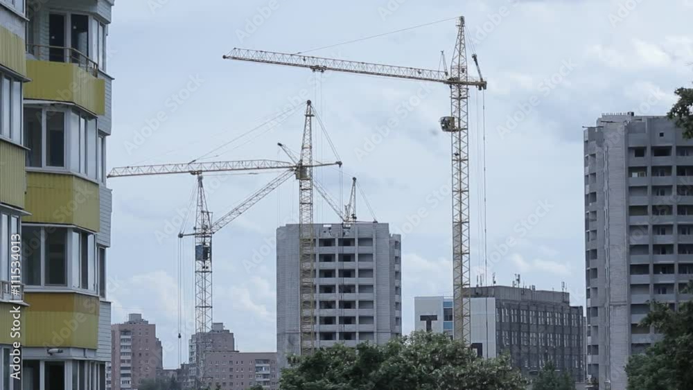construction of a new house in the city with the help of a crane construction of a new house in the city with the help of a crane