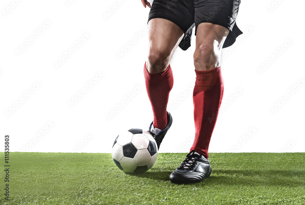 football player in red socks and black shoes running and dribbling with the ball playing on grass football player in red socks and black shoes running and dribbling with the ball playing on grass