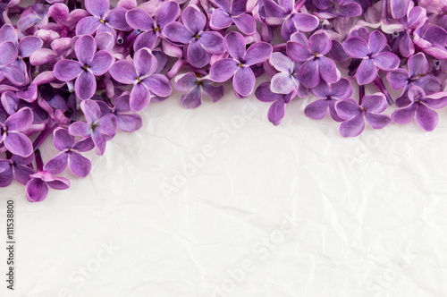 Purple lilac flowers on white textile