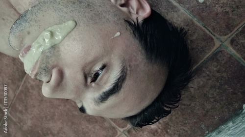 Drunk man with vomit on his face on the floor 