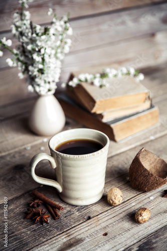 Large Cup of coffee on vintage wooden background. Spring flowers