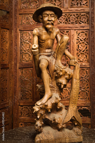Wooden statue of the chinese fisherman