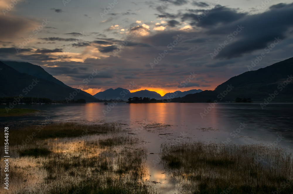 Loch Leven in Glencoe with colorful sunset in background, Highland, Scotland