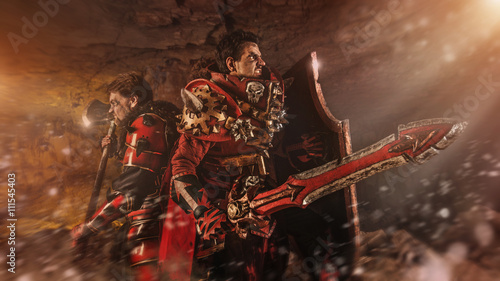 Attack of powerful knights in heavy armor on the dungeon backgro
