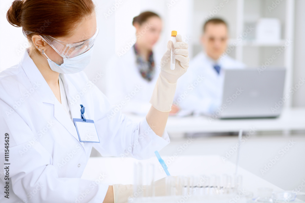 Scientific research team with clear solution in laboratory Scientific research team with clear solution in laboratory