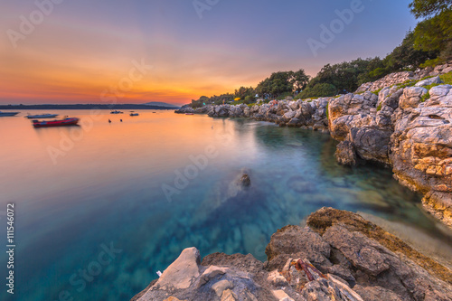 Colorful sunset over the rocky coast of Croatia photo