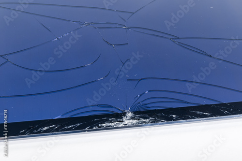 Broken iPad with a shattered glass screen on white background