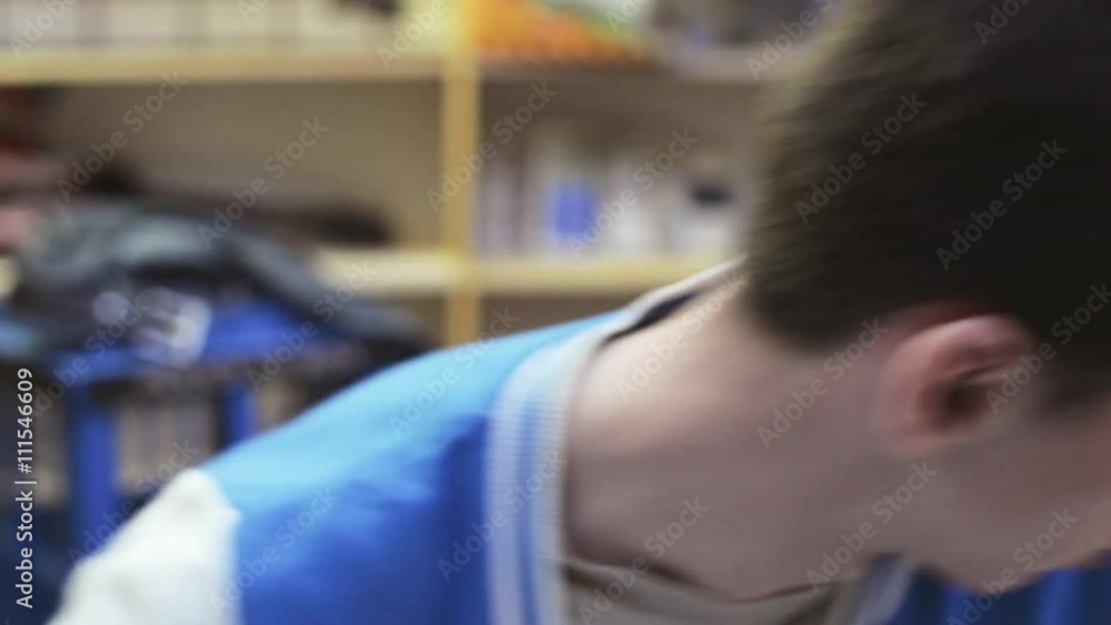Young brunette teen boy in jacket look around in room, dancing by shoulders. Smile. Teenager. Portrait Young brunette teen boy in jacket look around in room, dancing by shoulders. Smile. Teenager. Portrait