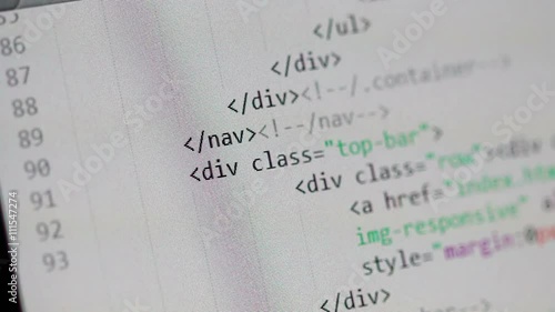Scrolling through a page of HTML code in a light-color code editor window. Scrolling stops from time to time to show some of the HTML tags