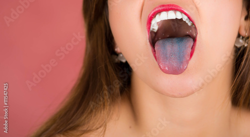 Woman with open mouth spreading tongue colored in blue with pink background and hair down