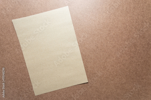 Brown paper note on business wood desk with copy space.
