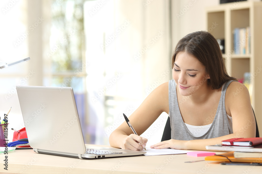 Student studying writing notes Student studying writing notes