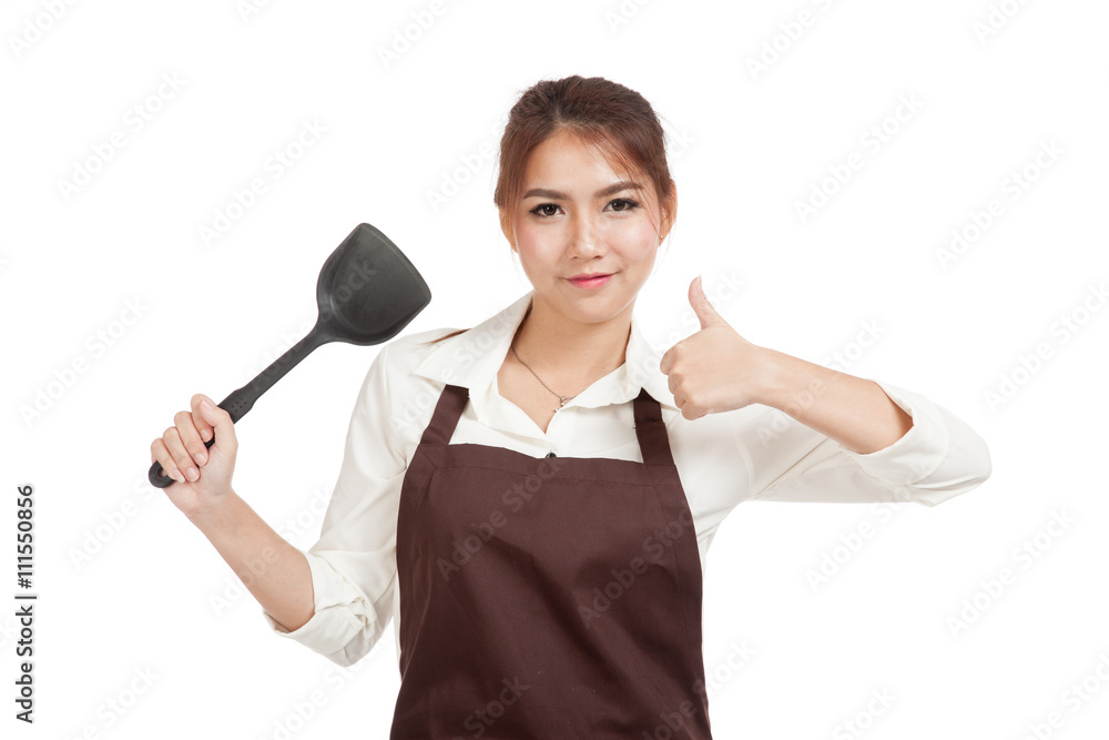 Asian beautiful girl thumbs up with spade of frying pan Asian beautiful girl thumbs up with spade of frying pan