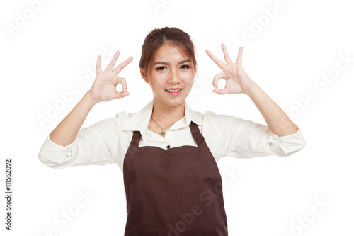 Asian waitress in apron show two OK sign