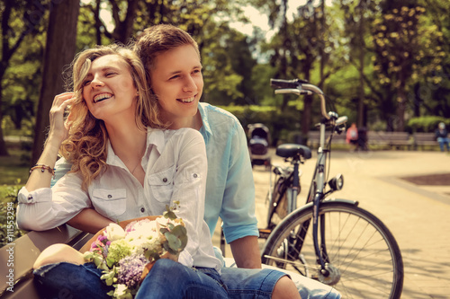 Happy man and cute blond woman with flowers.