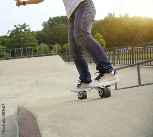 Fototapeta Naklejka Na Ścianę i Meble -  freeline skateboarder legs riding on freeline at skatepark