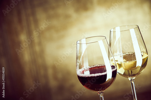 Wineglasses of red and white wine side by side