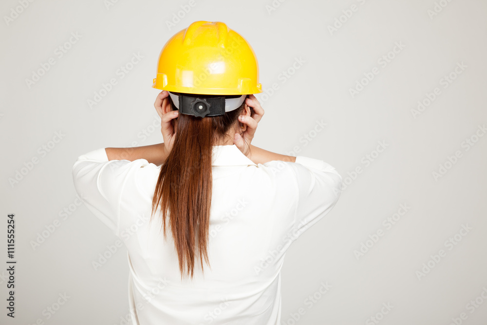 Back of Asian Engineer girl with hard hat got headache