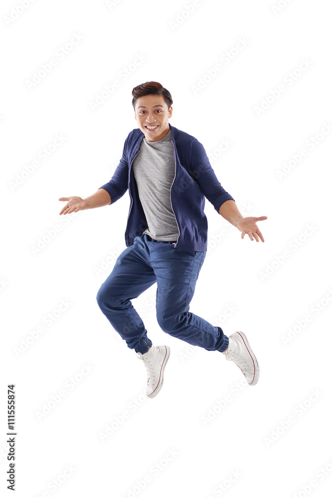 Surprised young man jumping, isolated on white Surprised young man jumping, isolated on white