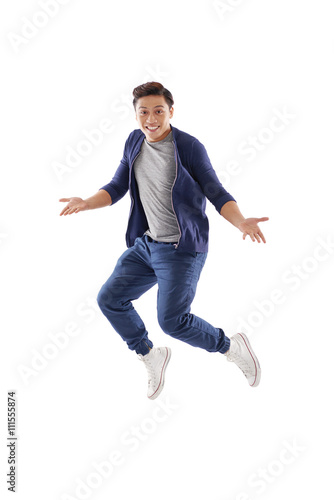 Surprised young man jumping, isolated on white