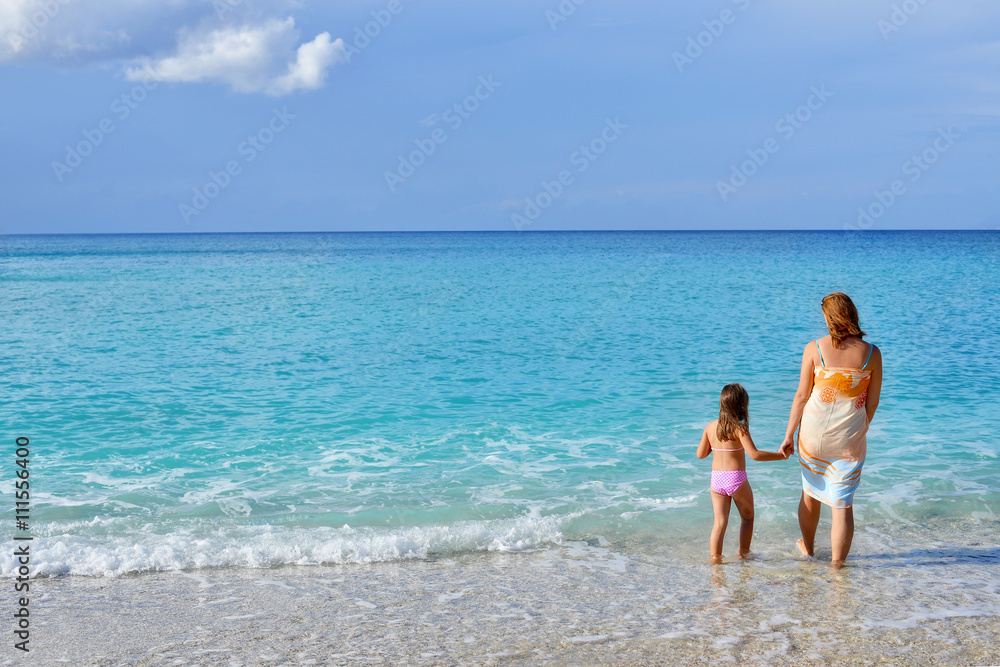 Adorable toddler girl enjoying her summer vacation at beach with Adorable toddler girl enjoying her summer vacation at beach with
