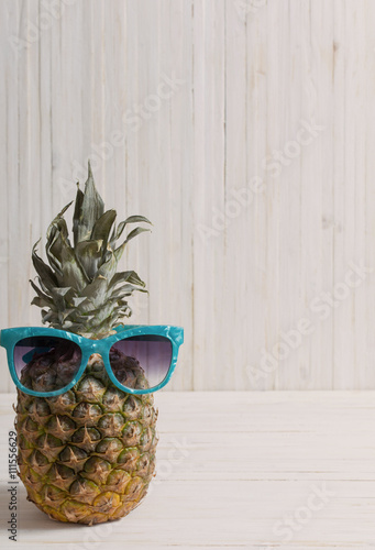 Ripe pineapple on a wooden background