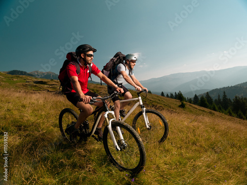 Fototapeta Naklejka Na Ścianę i Meble -  men riding mountain bikes