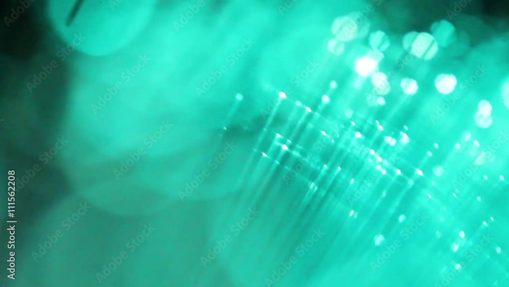 Defocused bokeh lights from optical fibers. Party decoration. Multicolored motion background. Rerto style disco design.