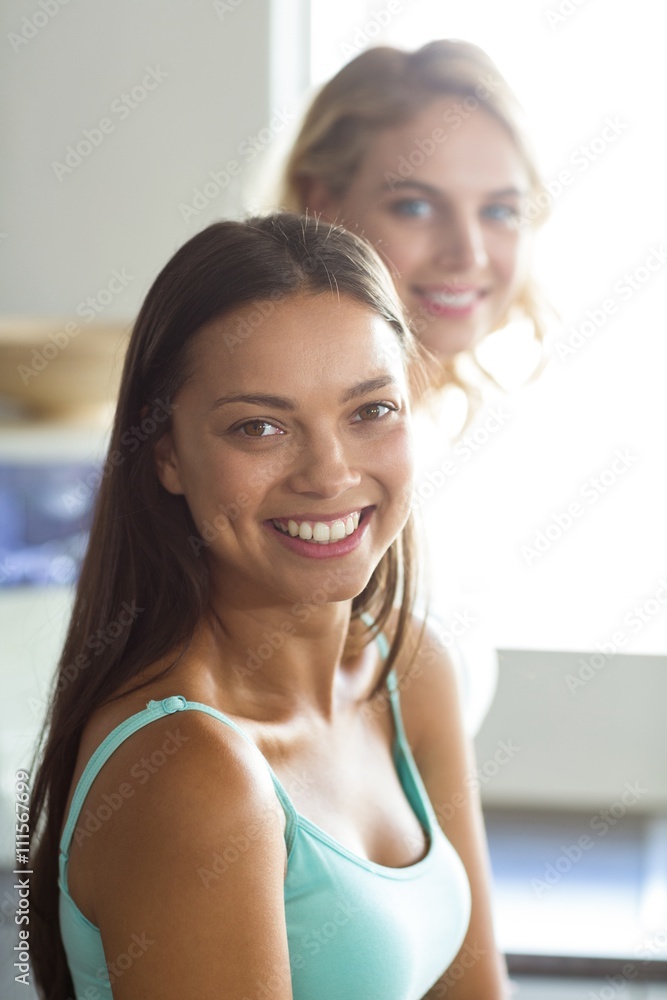 Smiling woman with female friend at home