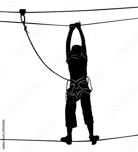 in adventure park rope ladder. Silhouette Adventure. Woman on cables in an adventure park on a difficult course