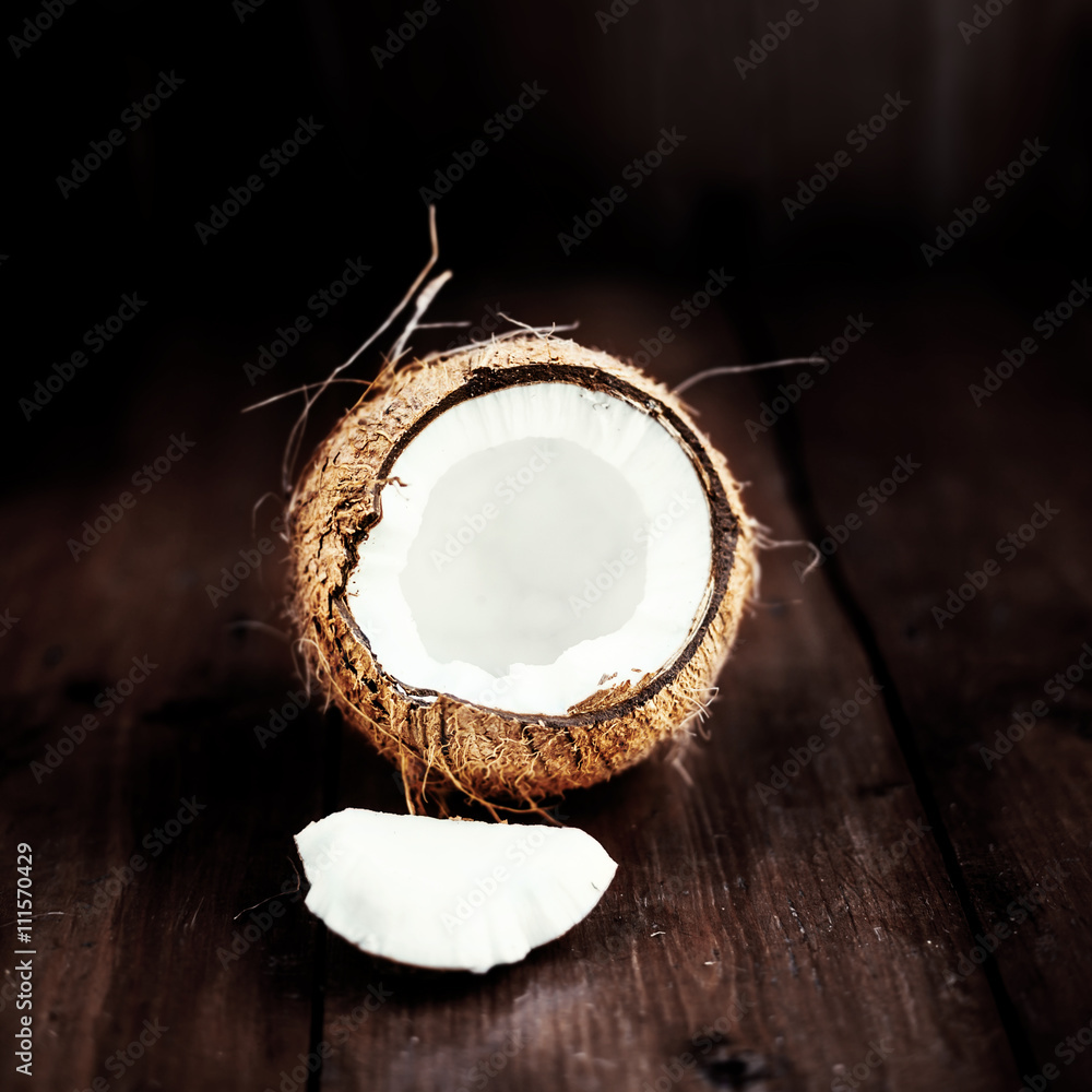 close up of a coconut on a wooden background with copy space close up of a coconut on a wooden background with copy space