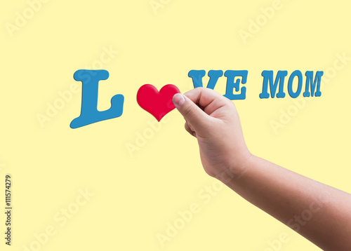 Isolated child or kid hand hold red heard form filling to blue text love mom for mother day background