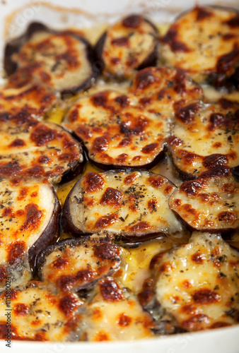 Baked eggplant in casserole with mozzarella cheese. Vertical shot