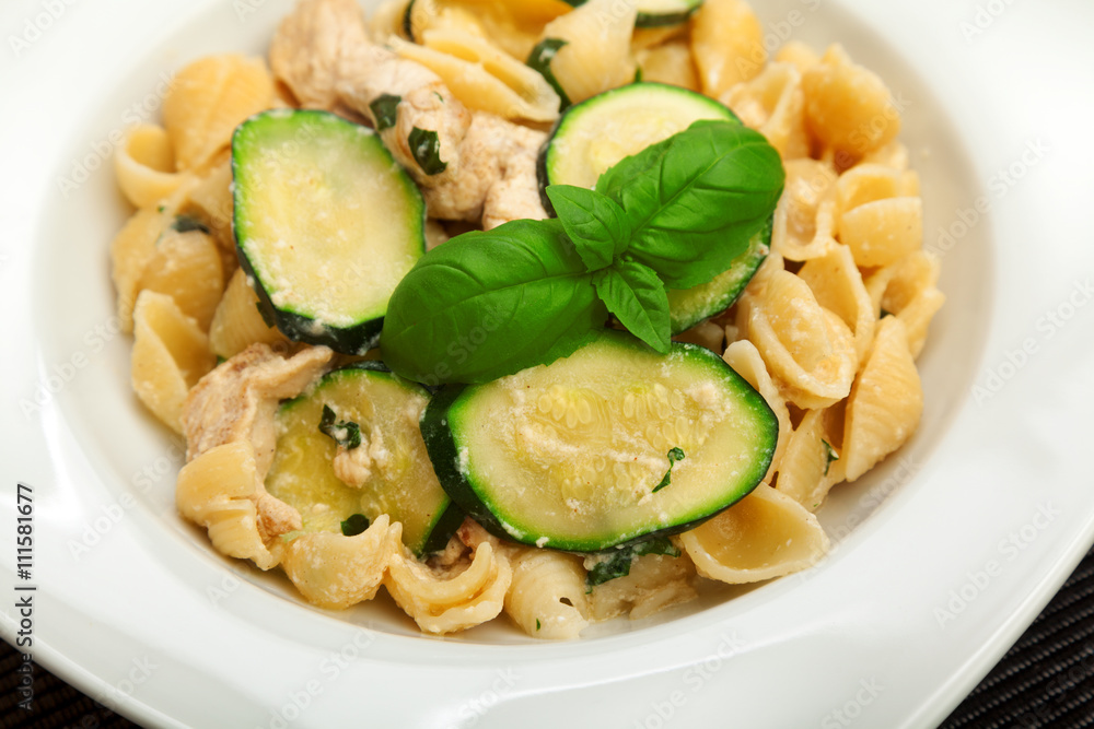 Pasta shell with chicken, zucchini, cream and basil. Horizontal shot. Pasta shell with chicken, zucchini, cream and basil. Horizontal shot.