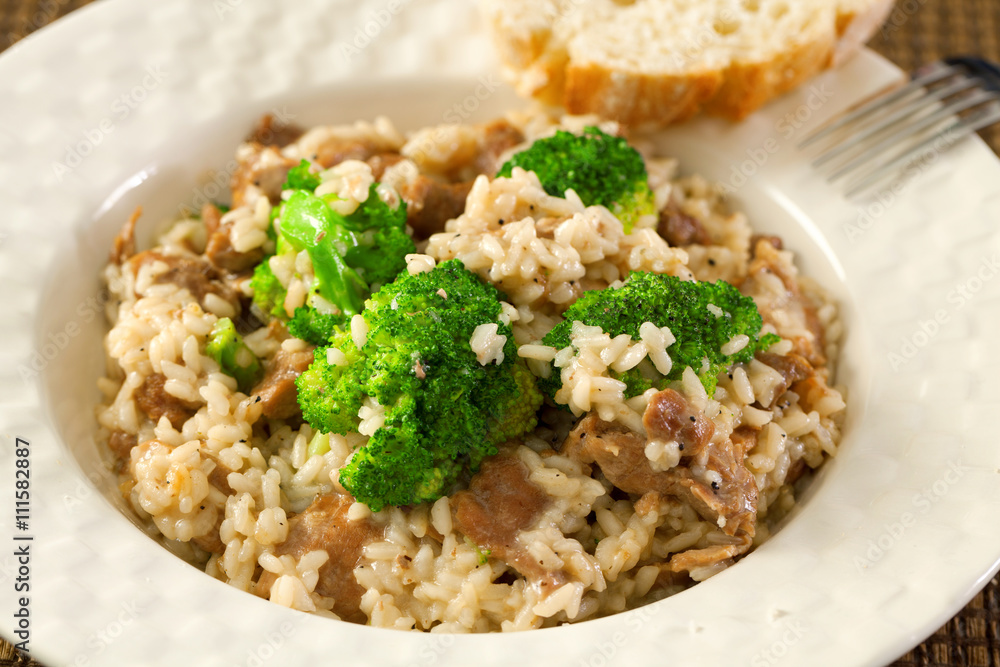 Slow cooked dish with chicken tights, rice and broccoli. Close up Slow cooked dish with chicken tights, rice and broccoli. Close up