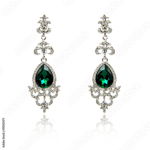 Pair of emerald earrings isolated on white 