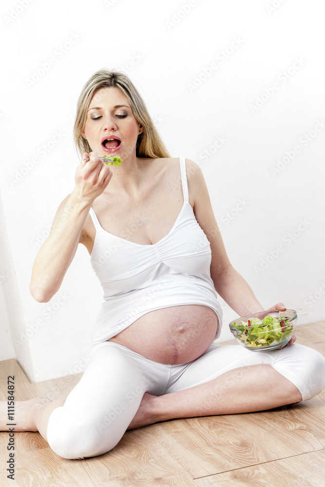 portrait of pregnant woman eating vegetable salad portrait of pregnant woman eating vegetable salad