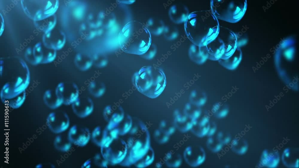 A lot of bubbles float to the surface of the blue water in the rays of light A lot of bubbles float to the surface of the blue water in the rays of light