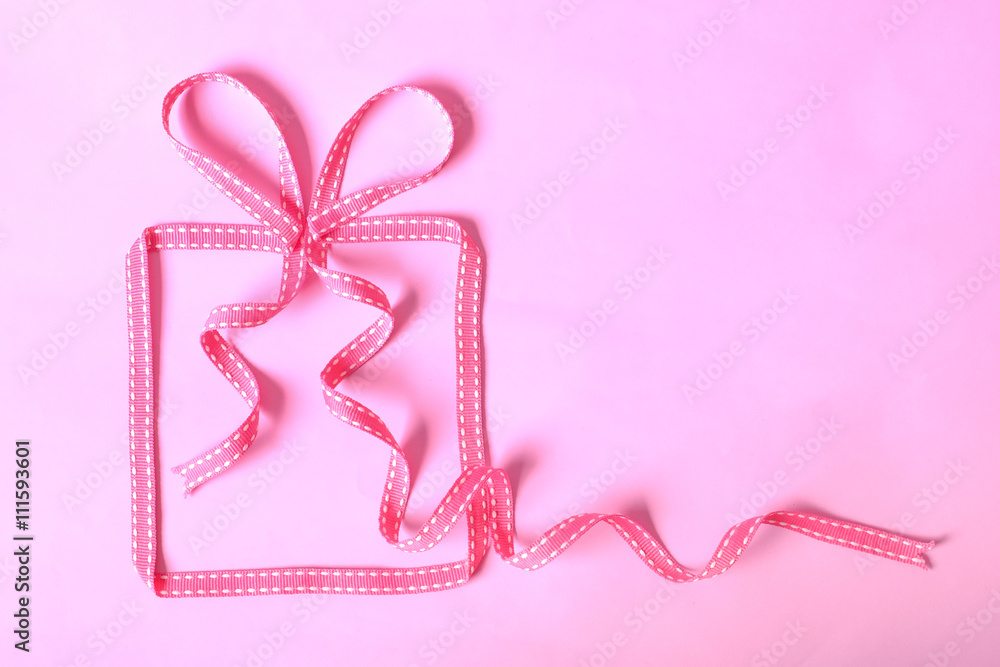 Banner with gift box made from pink ribbon
