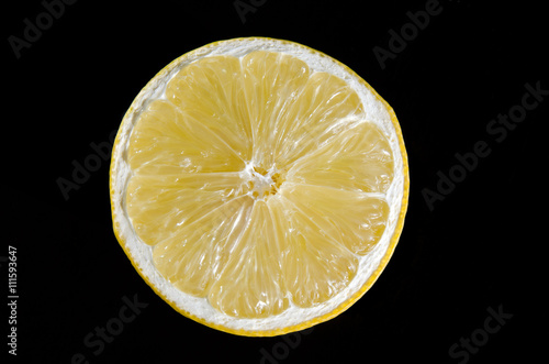Half a lemon on black background