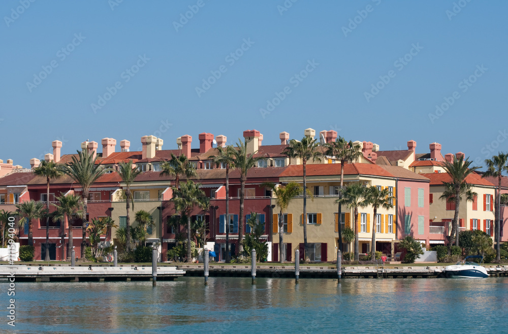 A row of colourful spanish waterside properties
