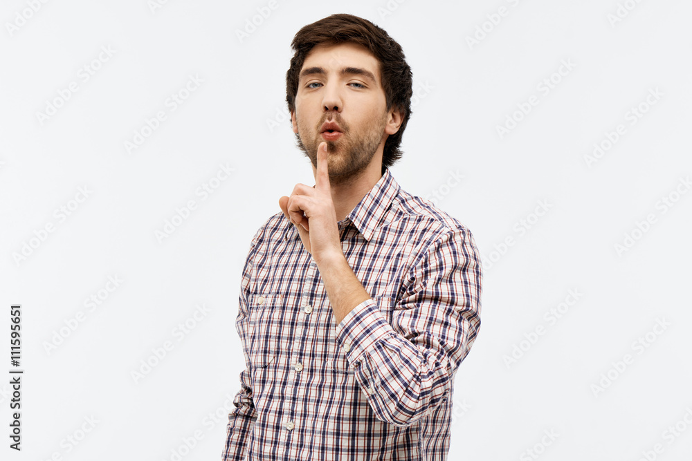 Portrait of handsome confident young man looking at camera blowi Portrait of handsome confident young man looking at camera blowi