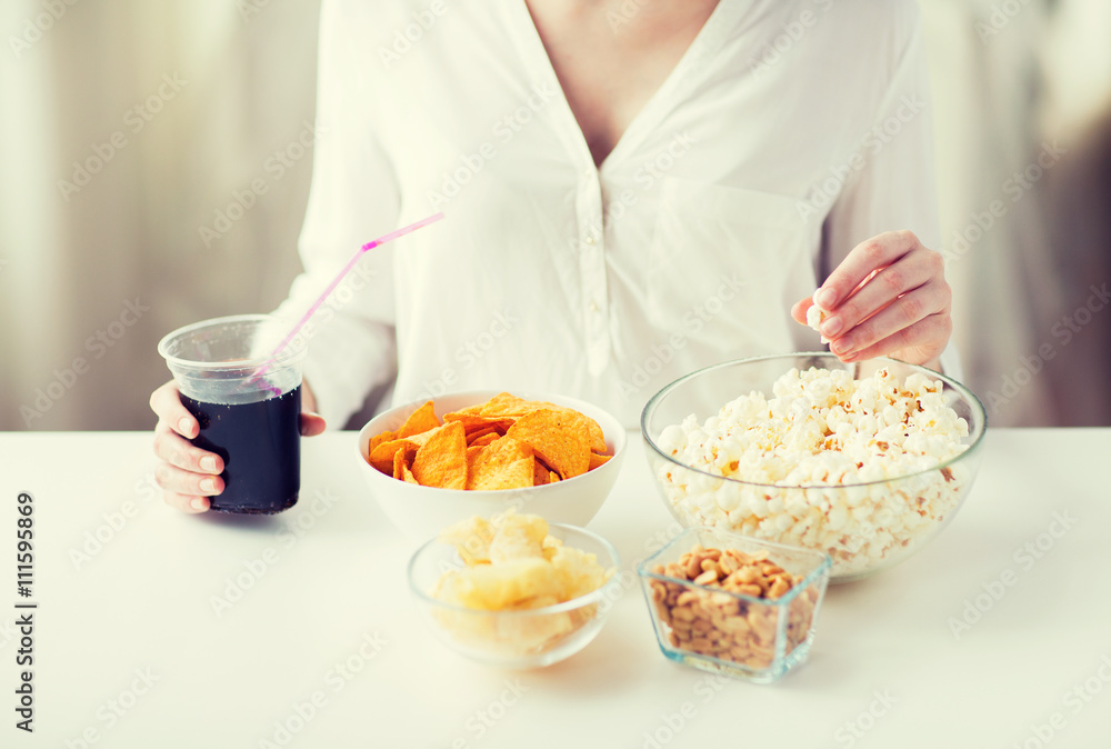 close up of woman with junk food and cola cup